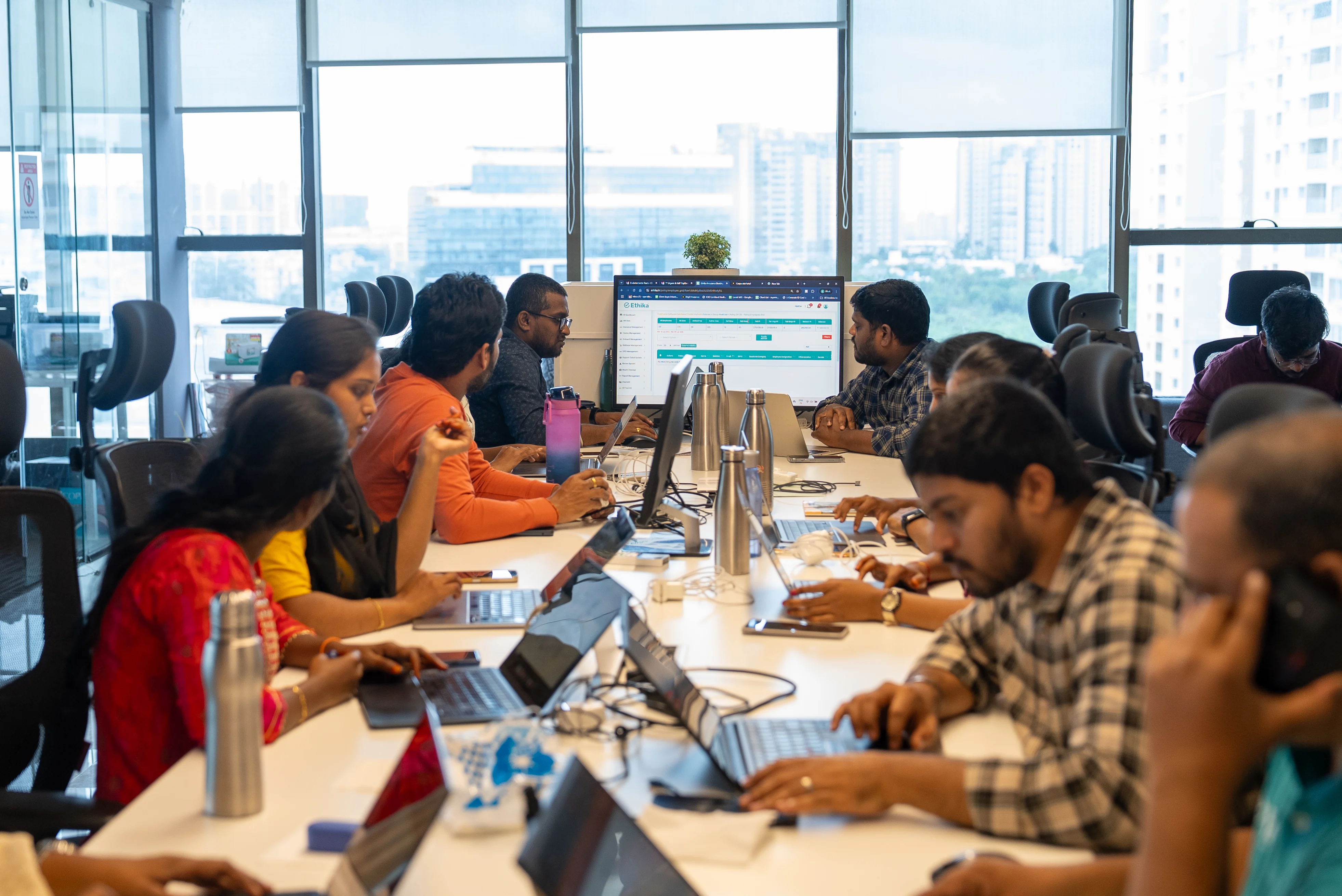 An aspirational photo of a happy and collaborative team in a modern office.
